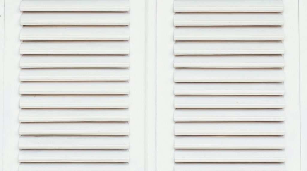 Hurricane shutters protecting a wide patio door opening