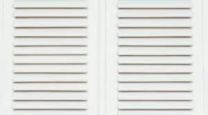 Hurricane shutters protecting a wide patio door opening